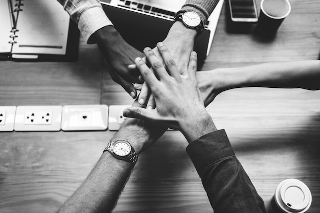 Team of business people stacking hands