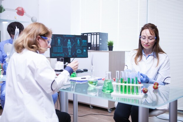 Team of different ages of scientist team in a research lab. Quality inspection.