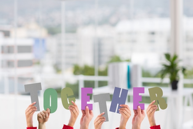 Free photo team holding letters with blurred background