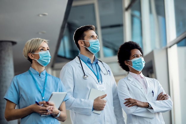 Free photo team of medical experts with face masks at the hospital during coronavirus pandemic