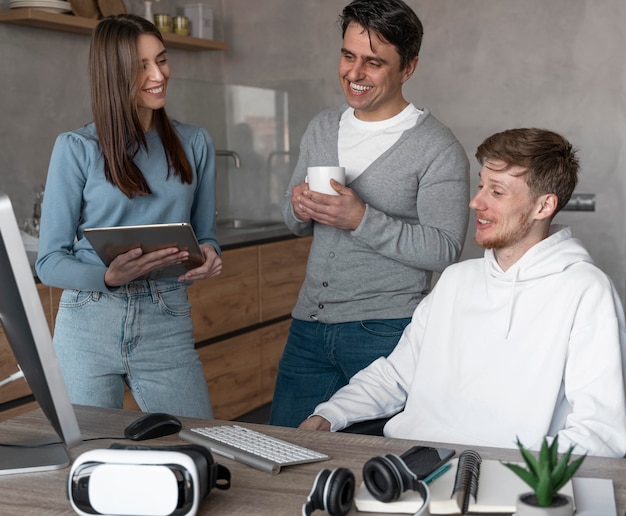 Team of people working in the media field with devices