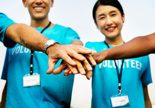 Team of volunteers stacking hands