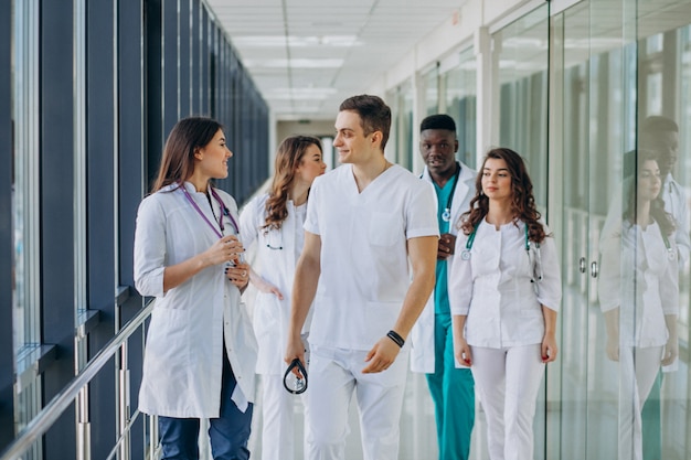 Free Photo team of young specialist doctors standing in the corridor of the hospital