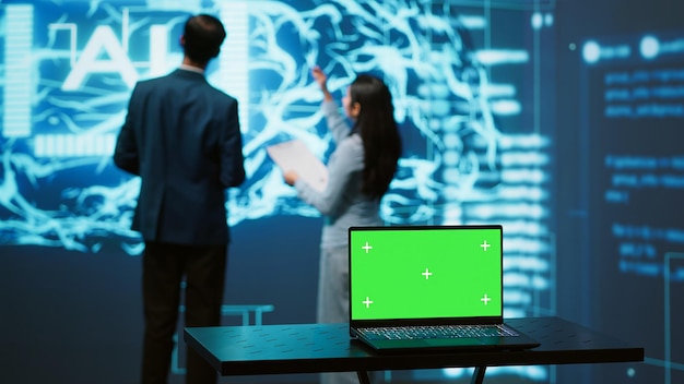 Free photo teamworking ai technicians using green screen laptop for business data analysis