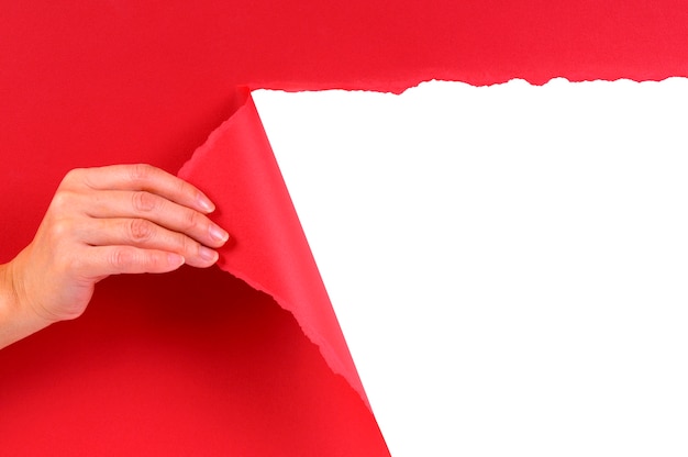 Free photo tearing a red cardboard