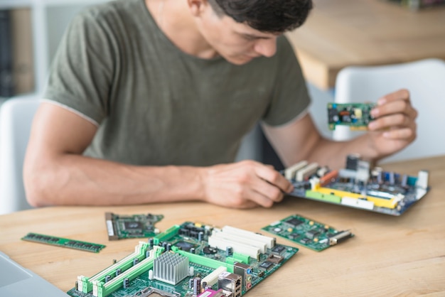 Free photo technician assembling the motherboard parts