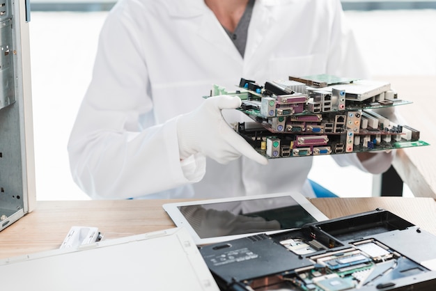 Technician holding computer parts in workshop