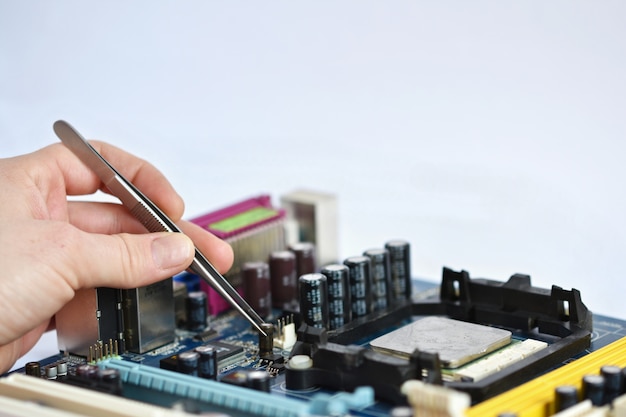 Free Photo technician placing a chip with pliers