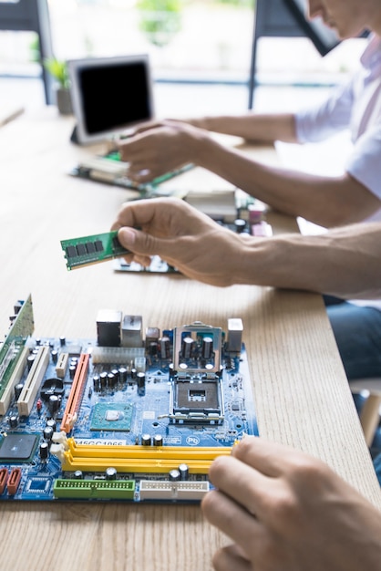 Free photo technician repairing the computer motherboard