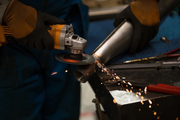 Technician worker cutting metal with many sharp sparks Using equipments to cat iron