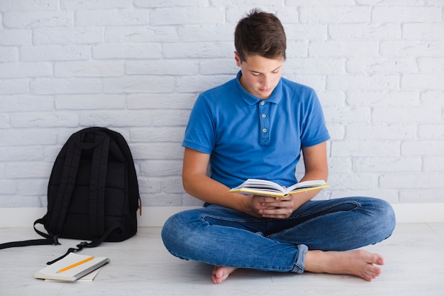 Teen boy reading book