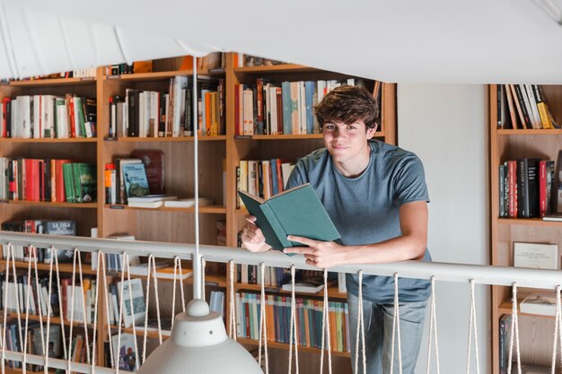 Teen boy with book looking at camera 