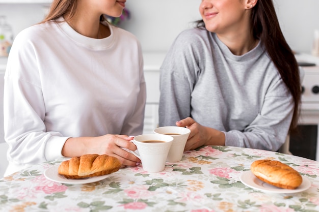 Teen couple drinking coffee at the table