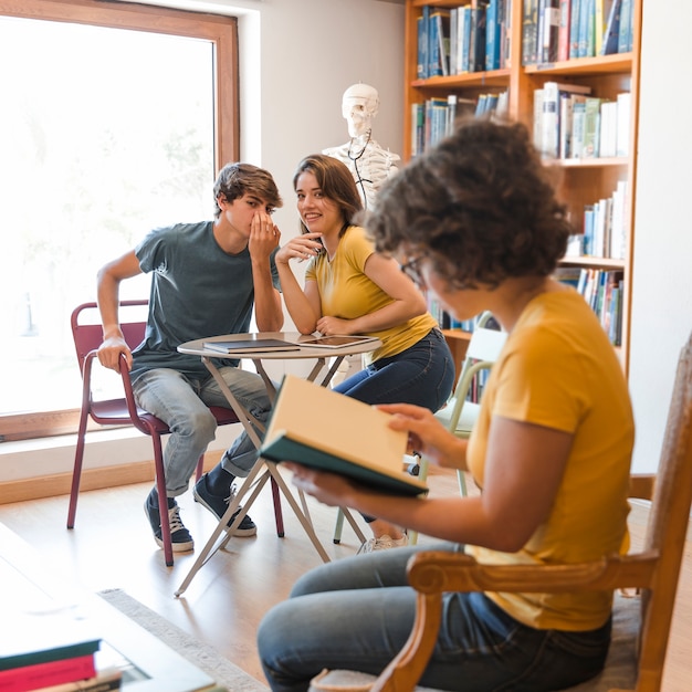 Free Photo teen couple gossiping about classmate