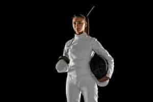 Free photo teen girl in fencing costume with sword in hand