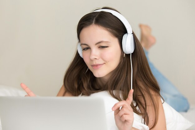 Teen girl listens choosing and buying songs online