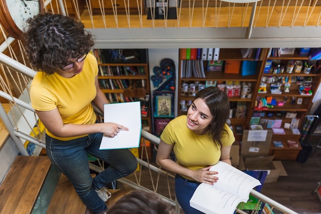 Free Photo teen girls studying on staircase