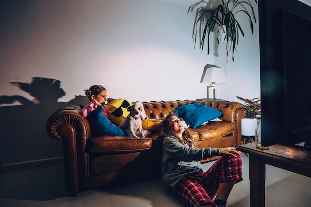 Teen girls watching comedy in dark