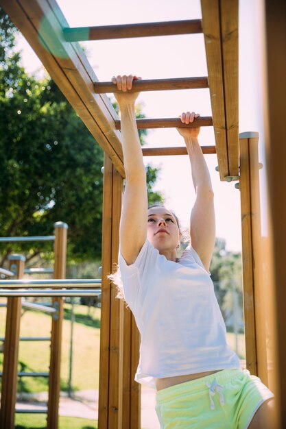 Teen schoolgirl working out at jungle gym