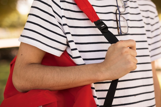 Free photo teen student carrying backpack on shoulder