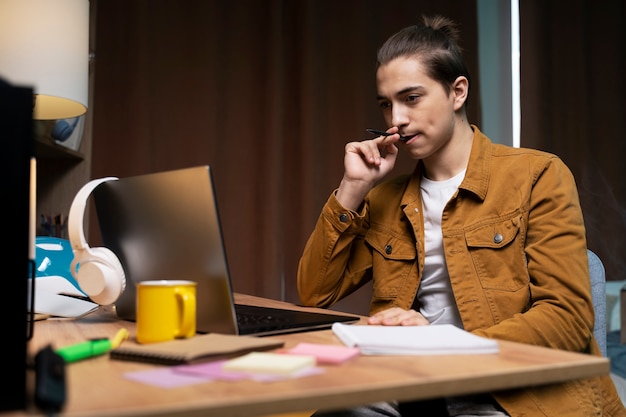 Teenage boy having a video call at home on laptop