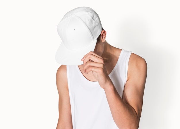 Teenage boy in white snapback cap and tank top street fashion shoot