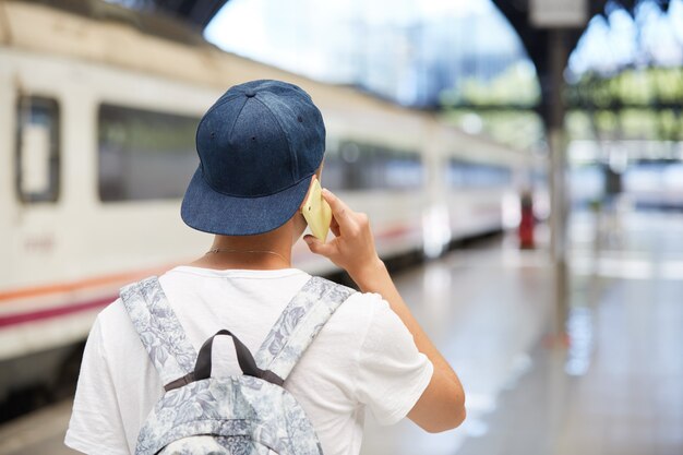 Teenage boy with backpack and wearing cap