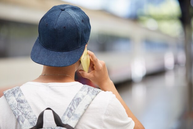 Teenage boy with backpack and wearing cap