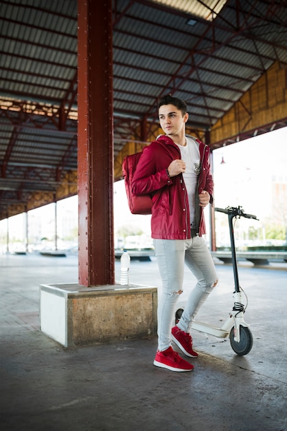 Free Photo teenage boy with scooter