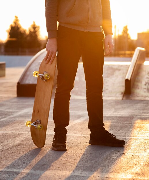 Teenage boy with skateboard close up