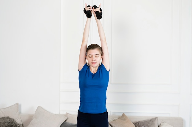 Teenage girl exercising with weights