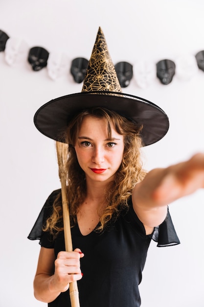 Free Photo teenage girl in pointy hat with broom