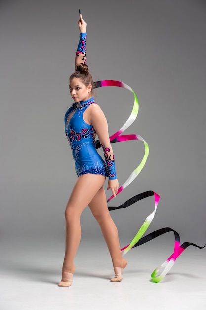 Free photo teenager doing gymnastics dance with ribbon