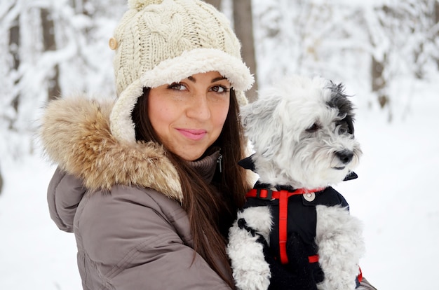 Free Photo teenager enjoying with her dog a day in the snow