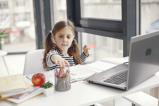 Free photo teenager girl looking at laptop. chiln at quarantine isolation period during pandemic. home schooling. social distancing. online school test.