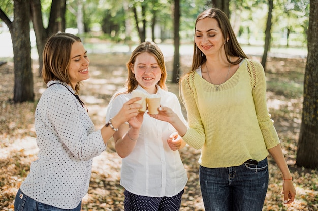 Teenager girls cheer with ice cream 