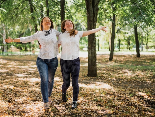 Teenager girls walking and hugging each other