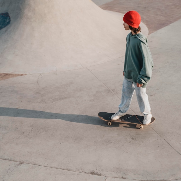 Teenager having fun at the skatepark with copy space