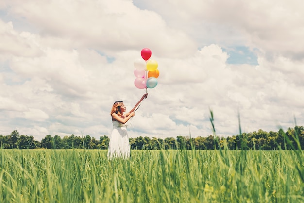 Teenager having fun with balloons outdoors