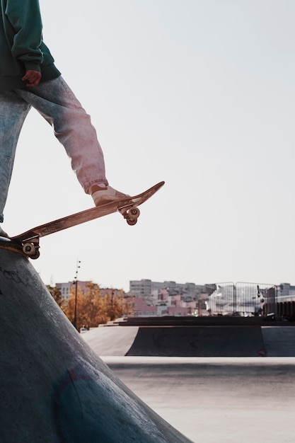 Teenager having fun with skateboard at the park and copy space