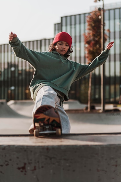 Free photo teenager having fun with skateboard at the park