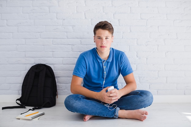 Teenager listening to music wit serious face