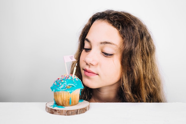 Teenager looking at muffin