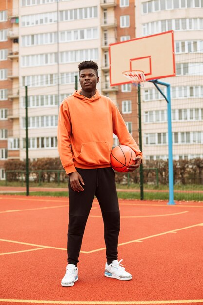 Teenager playing basketball outdoors