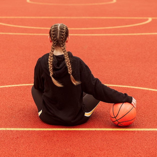 Teenager posing at the basketball field