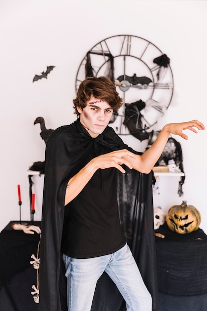 Free Photo teenager with halloween grim making zombie gestures