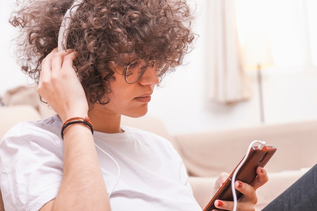 Free photo teenager with smartphone listening to music