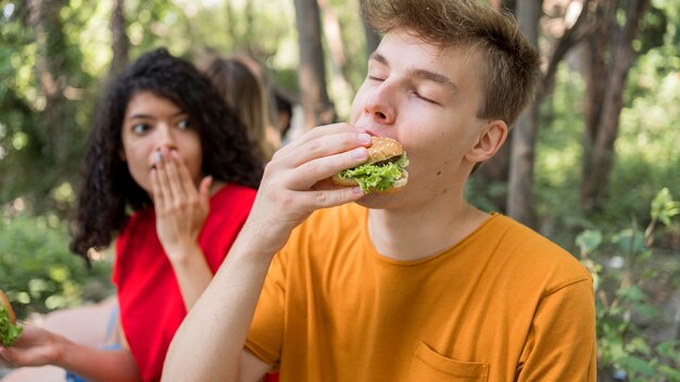 Teenagers enjoying a burger outdoors