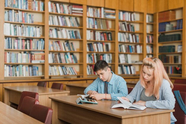 Teenagers reading in library