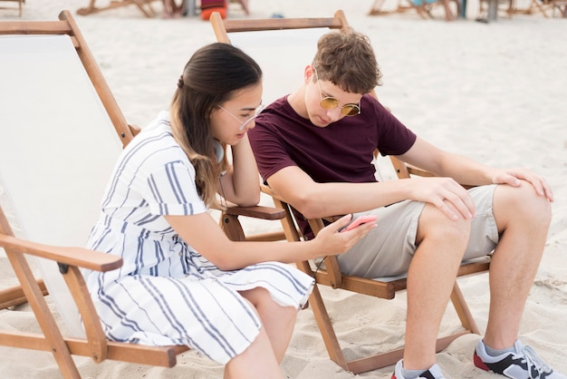 Teenagers relaxing together at the beach